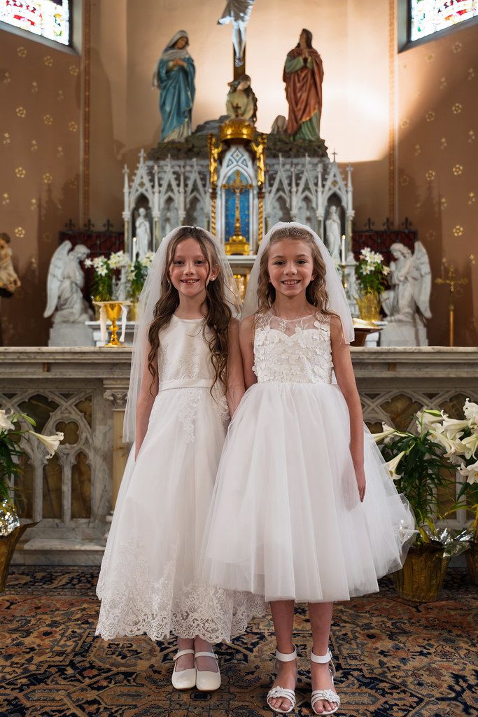 Sisters in white dresses at church